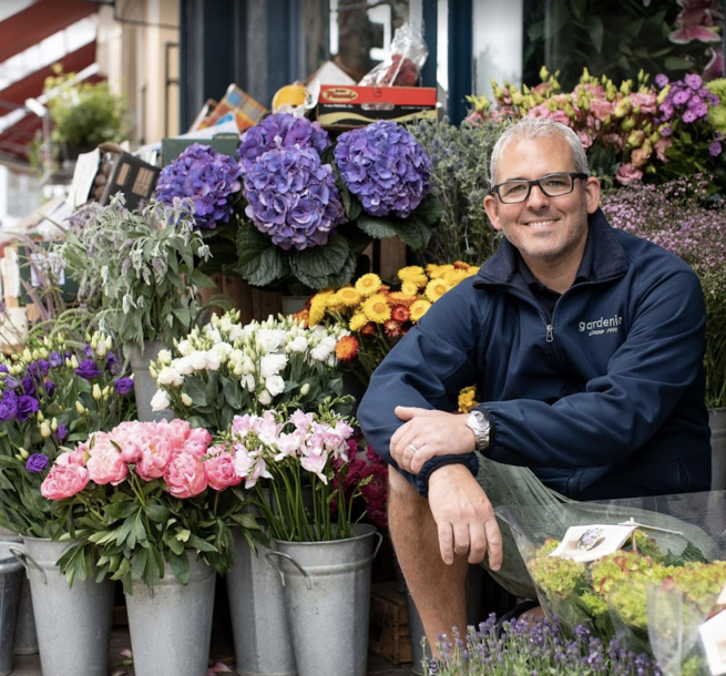 Gardenia - flowers and team member at front of shop