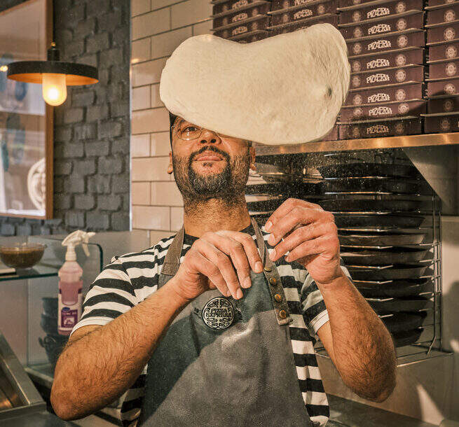 Pizza chef flipping dough