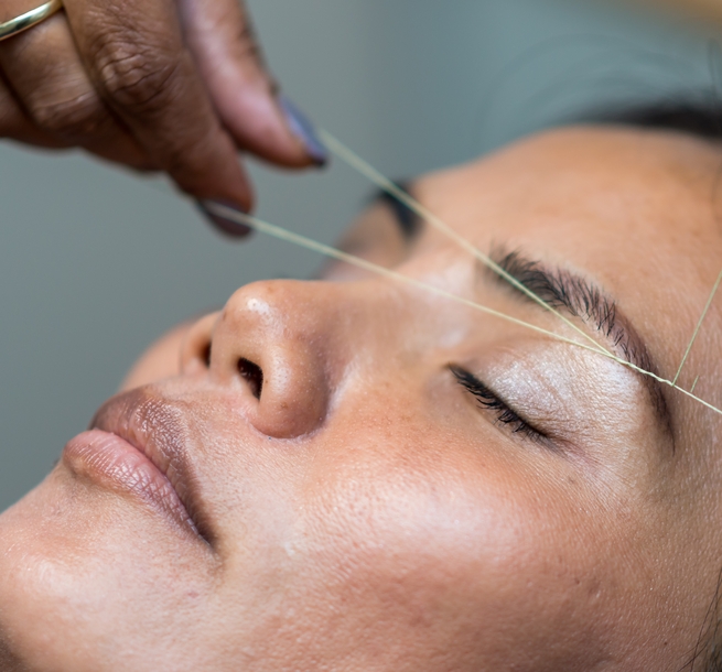 Sajna Hair & Beauty stock image of woman having eyebrows threaded