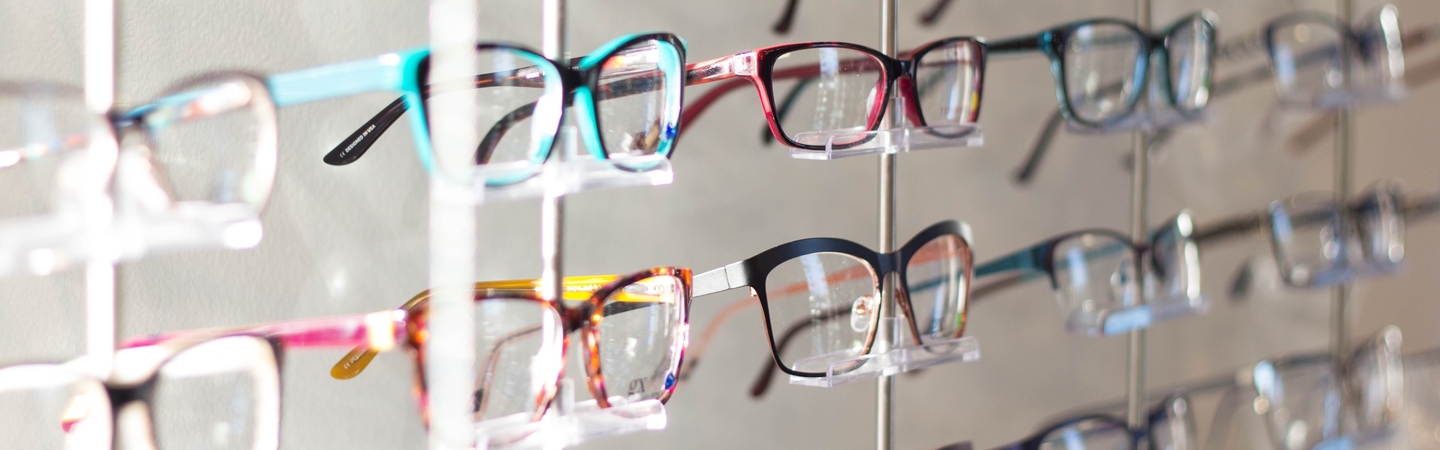 Opticians banner image - Rows of glasses